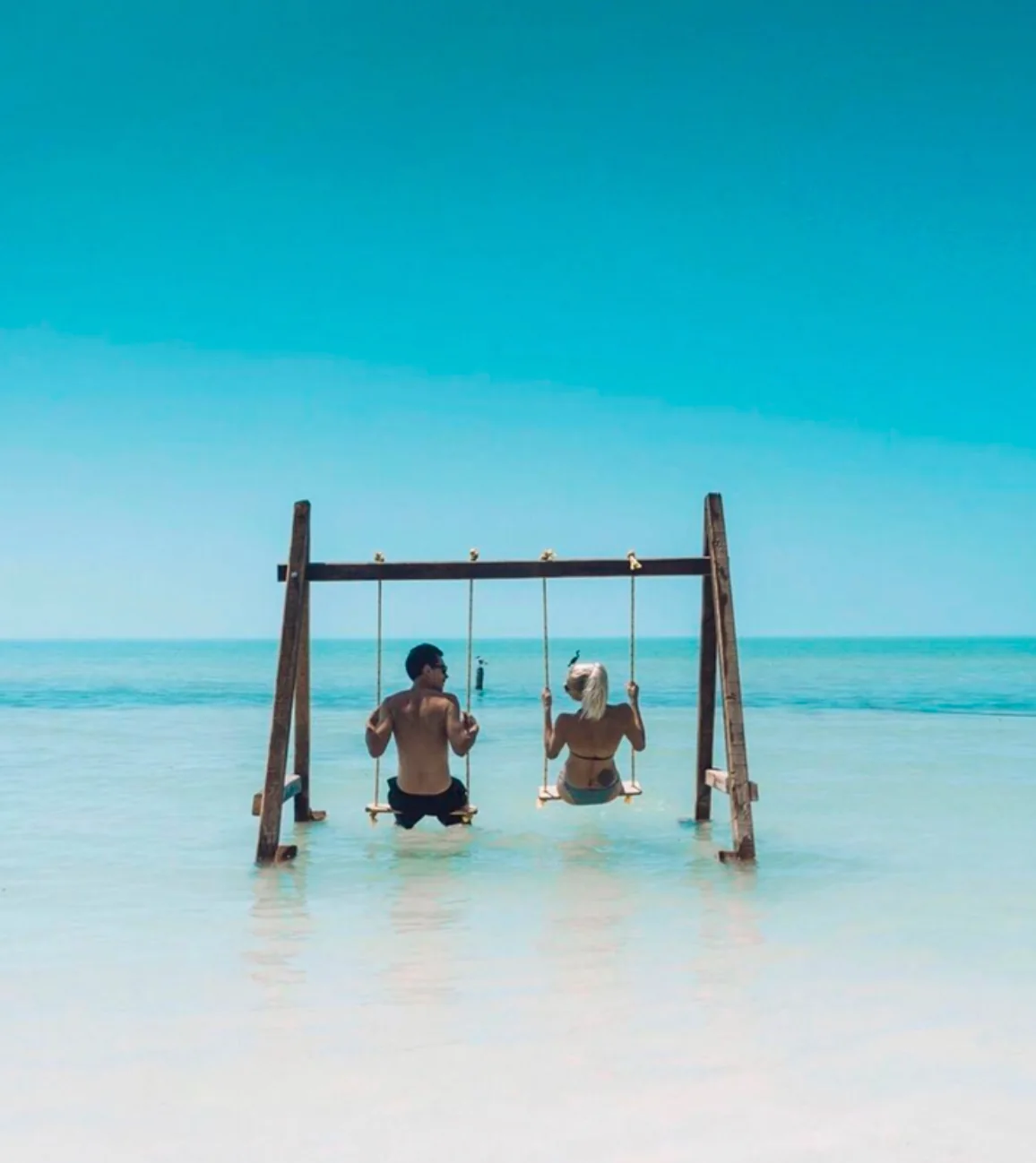 Visitors on waterfront swings