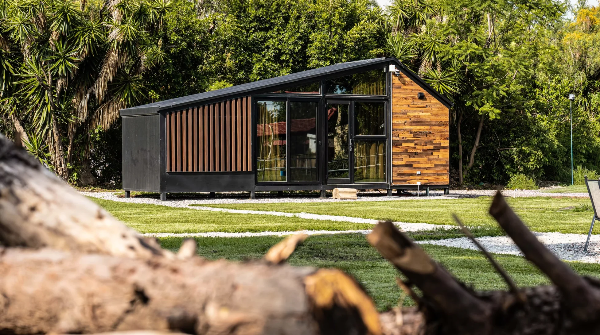 Illustrative modern compact modular house in a landscaped setting